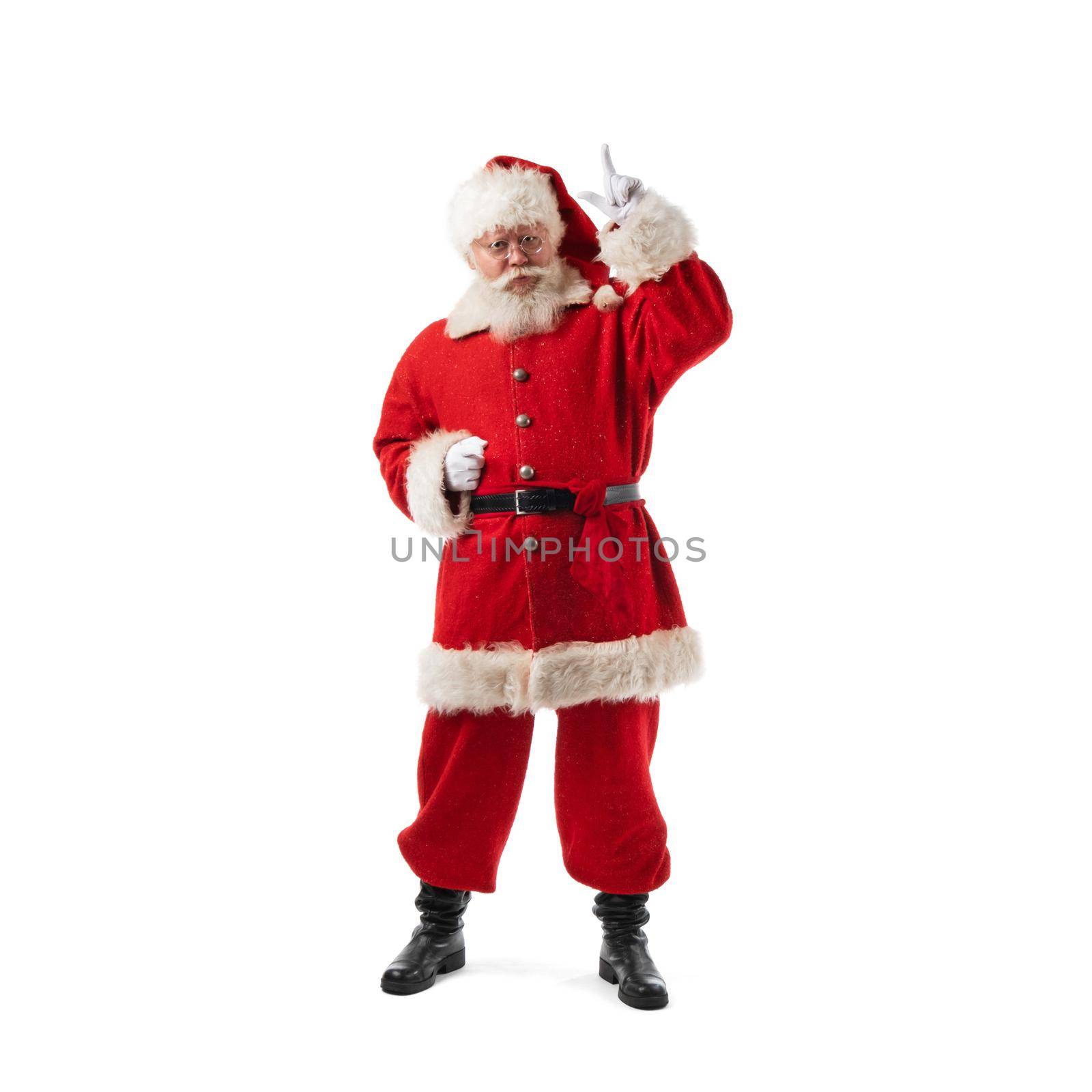 Full length portrait of Santa Claus pointing up studio isolated on white background