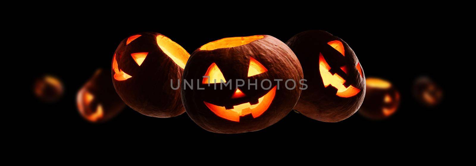 Glowing pumpkins levitate on a black background by butenkow