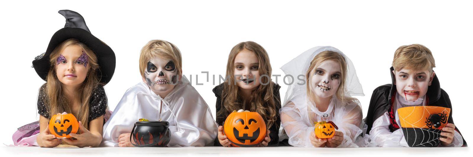 Group of children in fancy Halloween costumes with bucket with candies, isolated on white background, going trick or treating