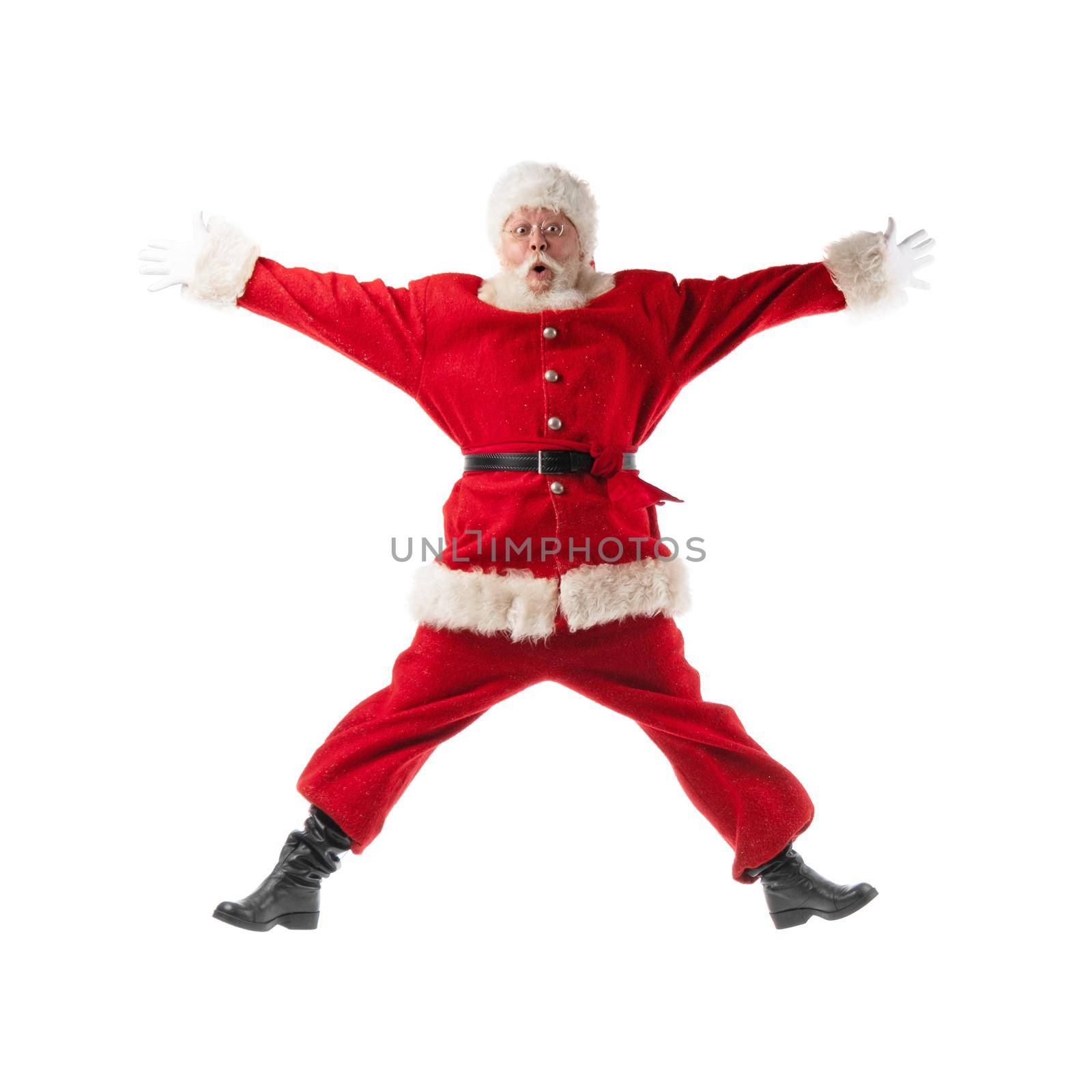 Santa Claus jumping with hands lifted upwards isolated on white background