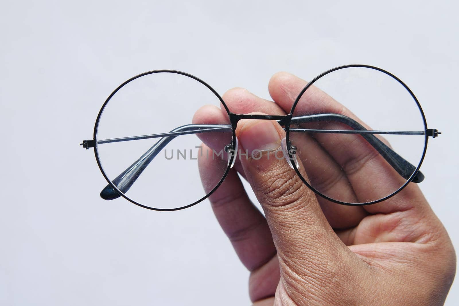 Close up of man hand holding eyeglass,