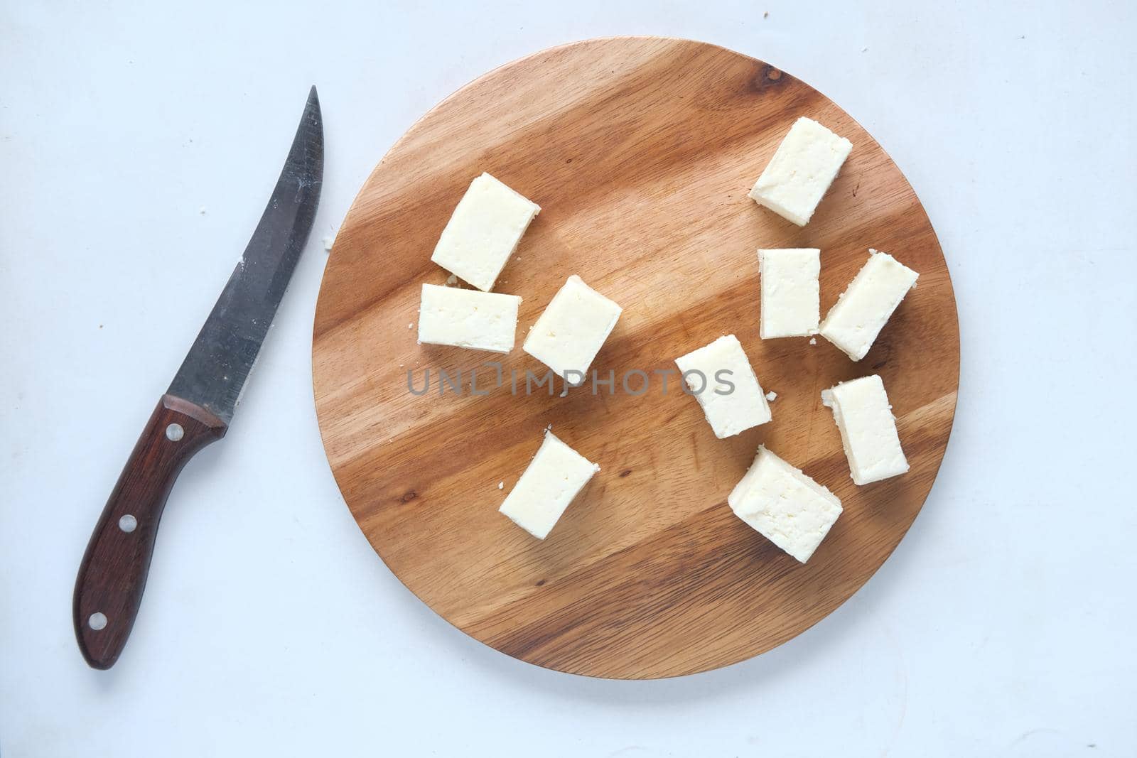 top view of cube shape fresh cheese on white background..