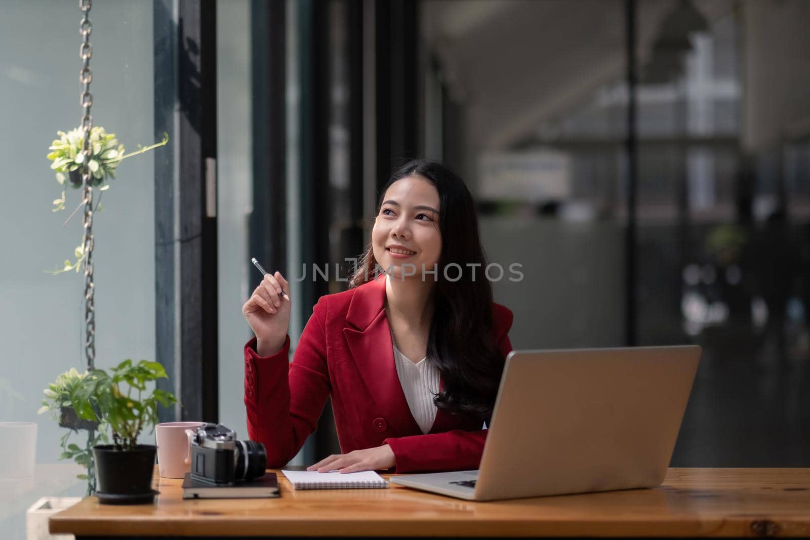 Portrait of attractive young asian woman working with laptop computer.