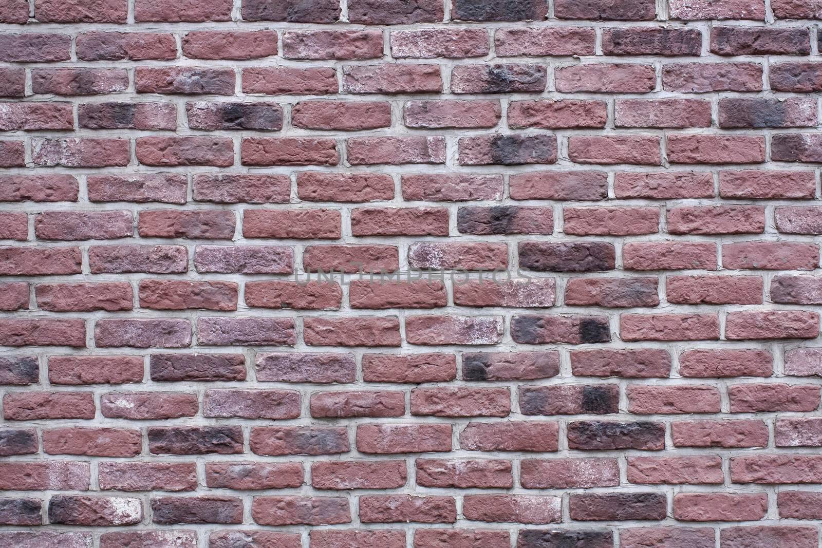 Textured background of an old dark red brick wall. Old brickwork.