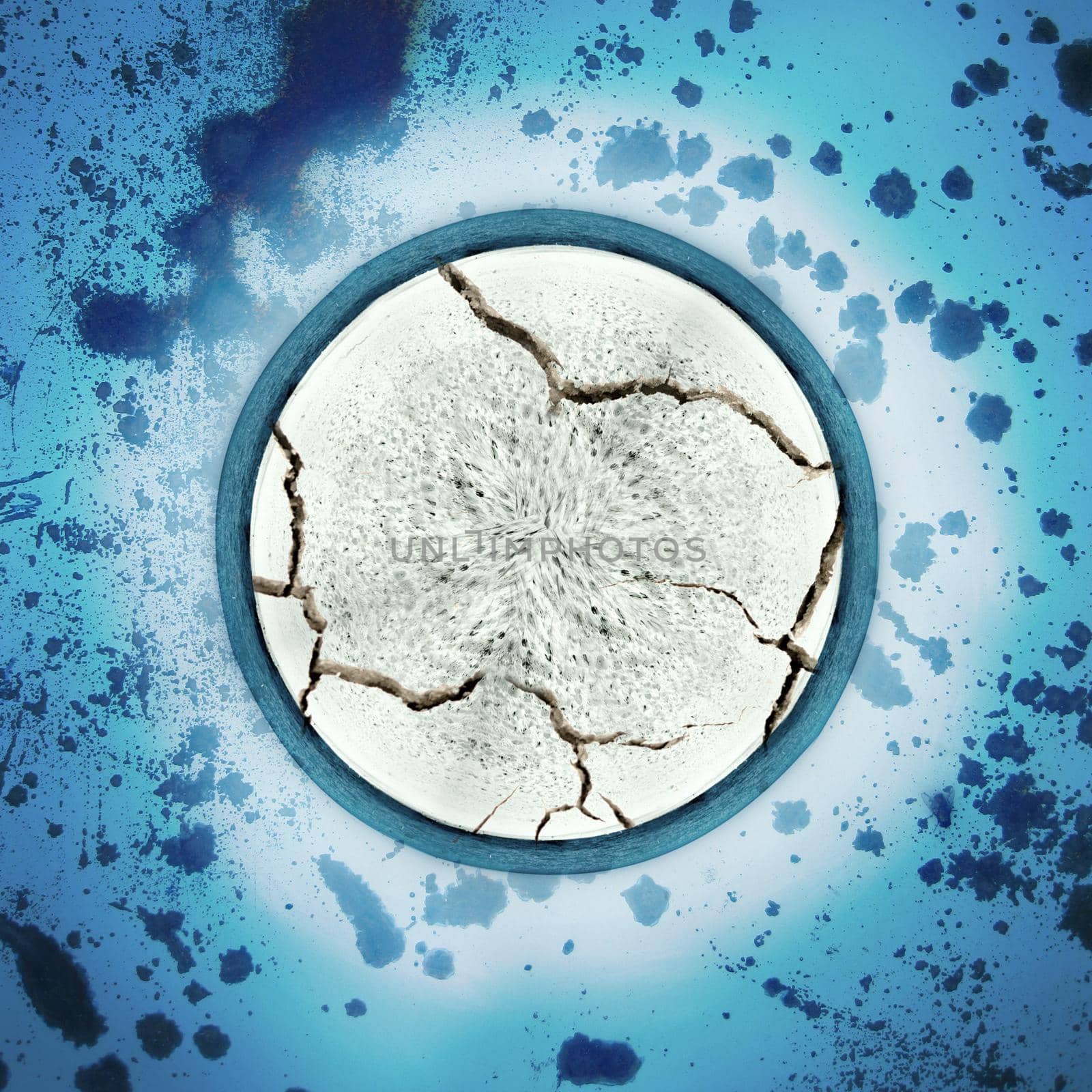Image of Abstract textured white cracking circle superimposed on a blue speckled surface