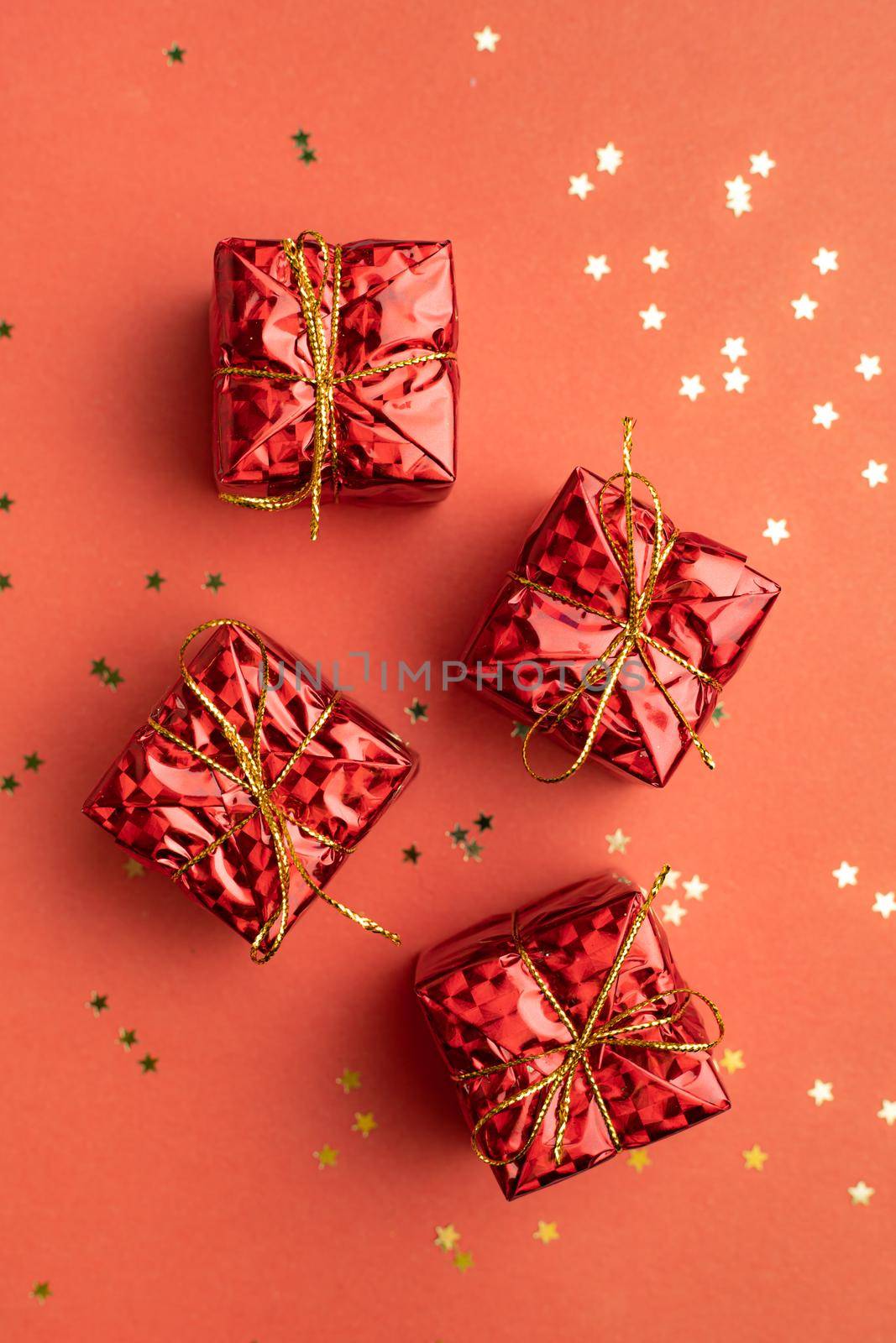 Red Christmas gifts on a red background . An article about the New year and Christmas. The choice of gifts. A red gift . New Year's background