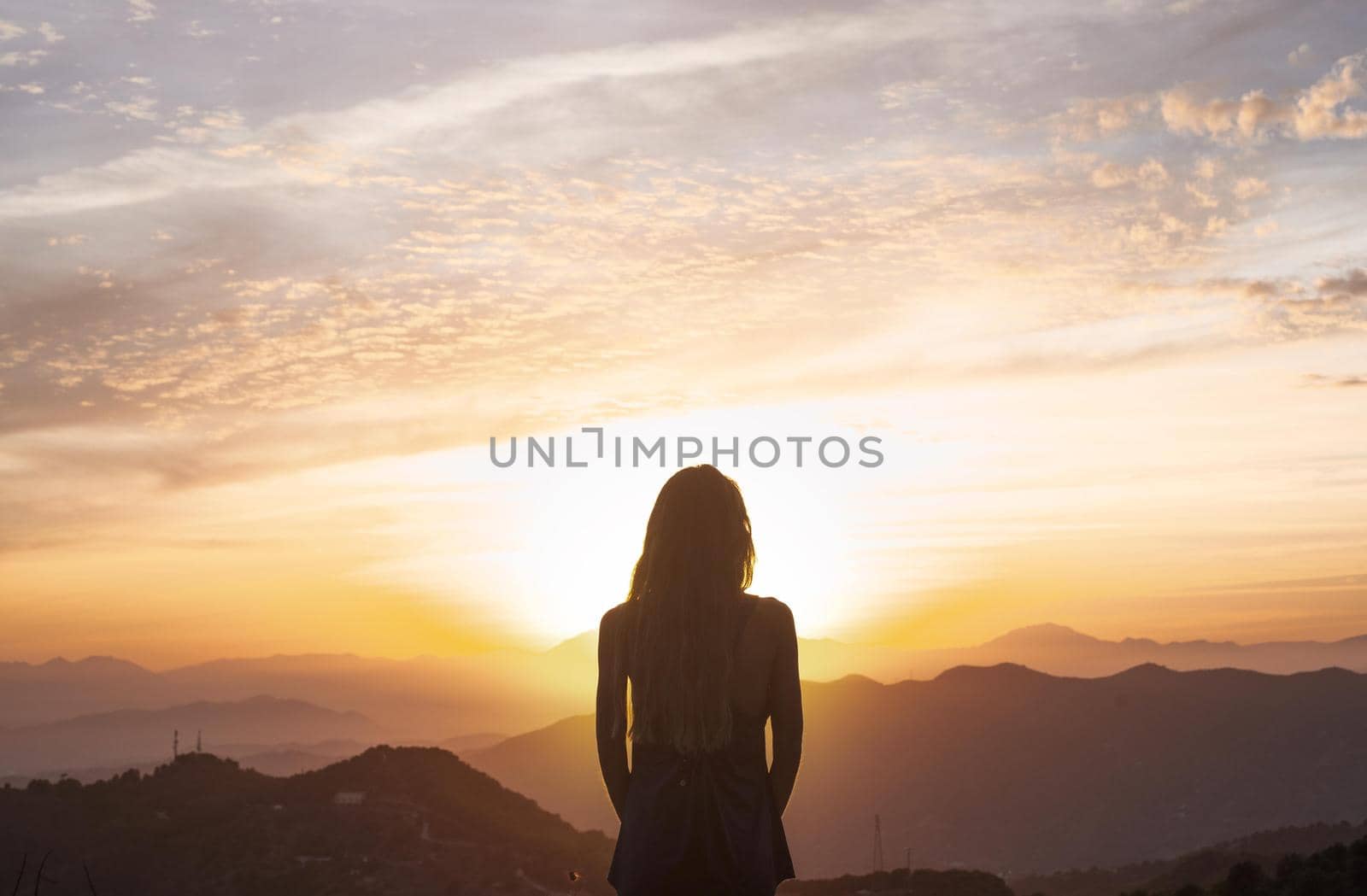 back view woman doing yoga while watching sunset. Resolution and high quality beautiful photo