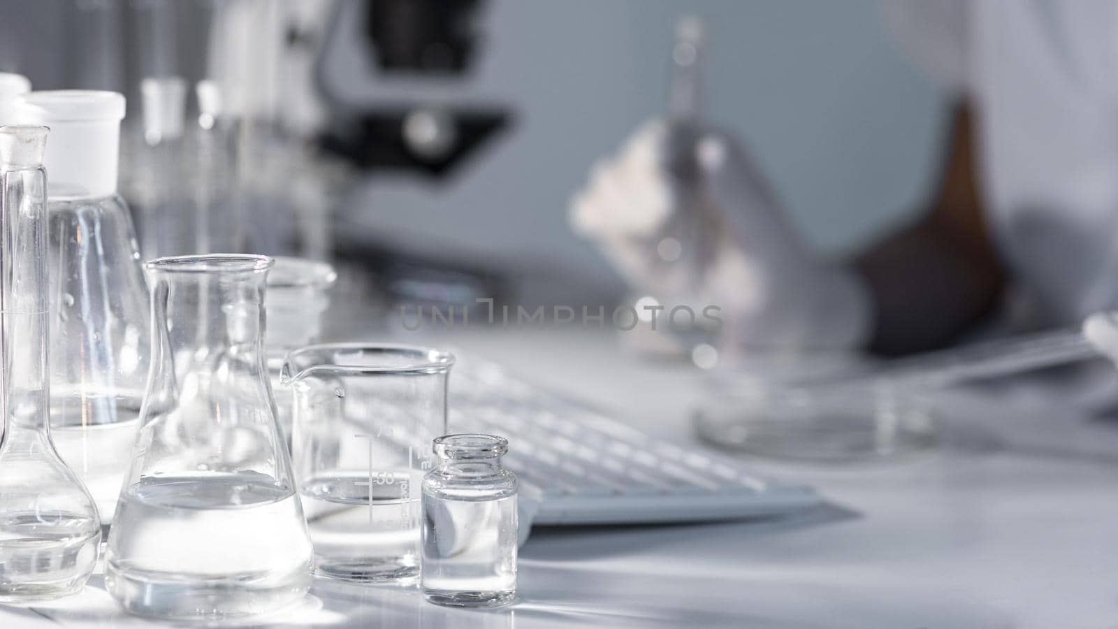 close up blurry researcher holding glassware. Resolution and high quality beautiful photo