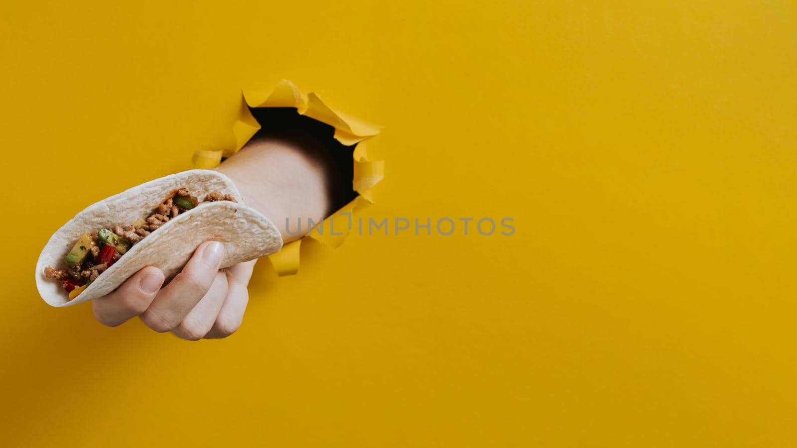 close up hand holding taco with copy space. Resolution and high quality beautiful photo