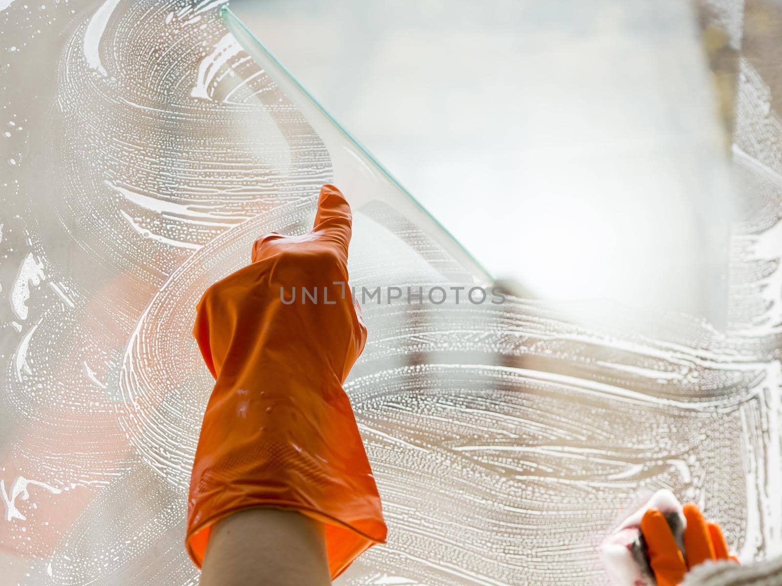close up hand with rubber glove cleaning window. Resolution and high quality beautiful photo