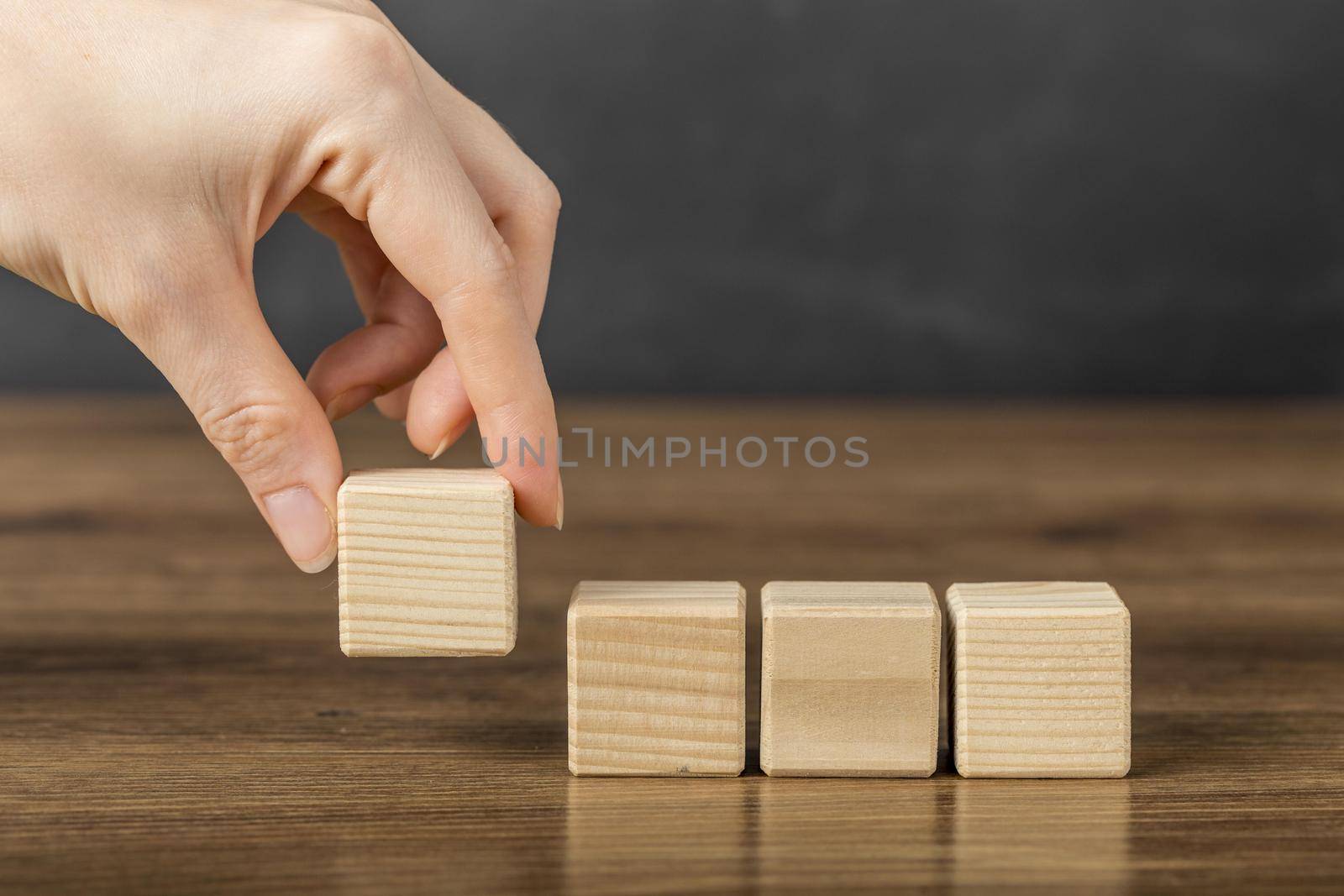 person placing wooden cube others. Resolution and high quality beautiful photo