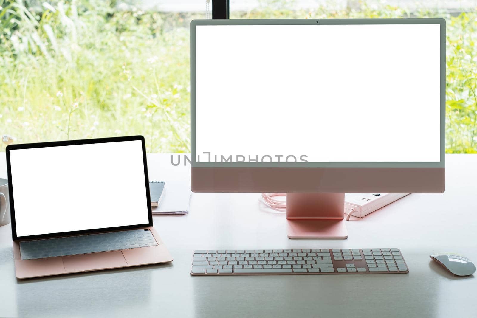 White blank screen monitor and laptop on modern working desk. by itchaznong