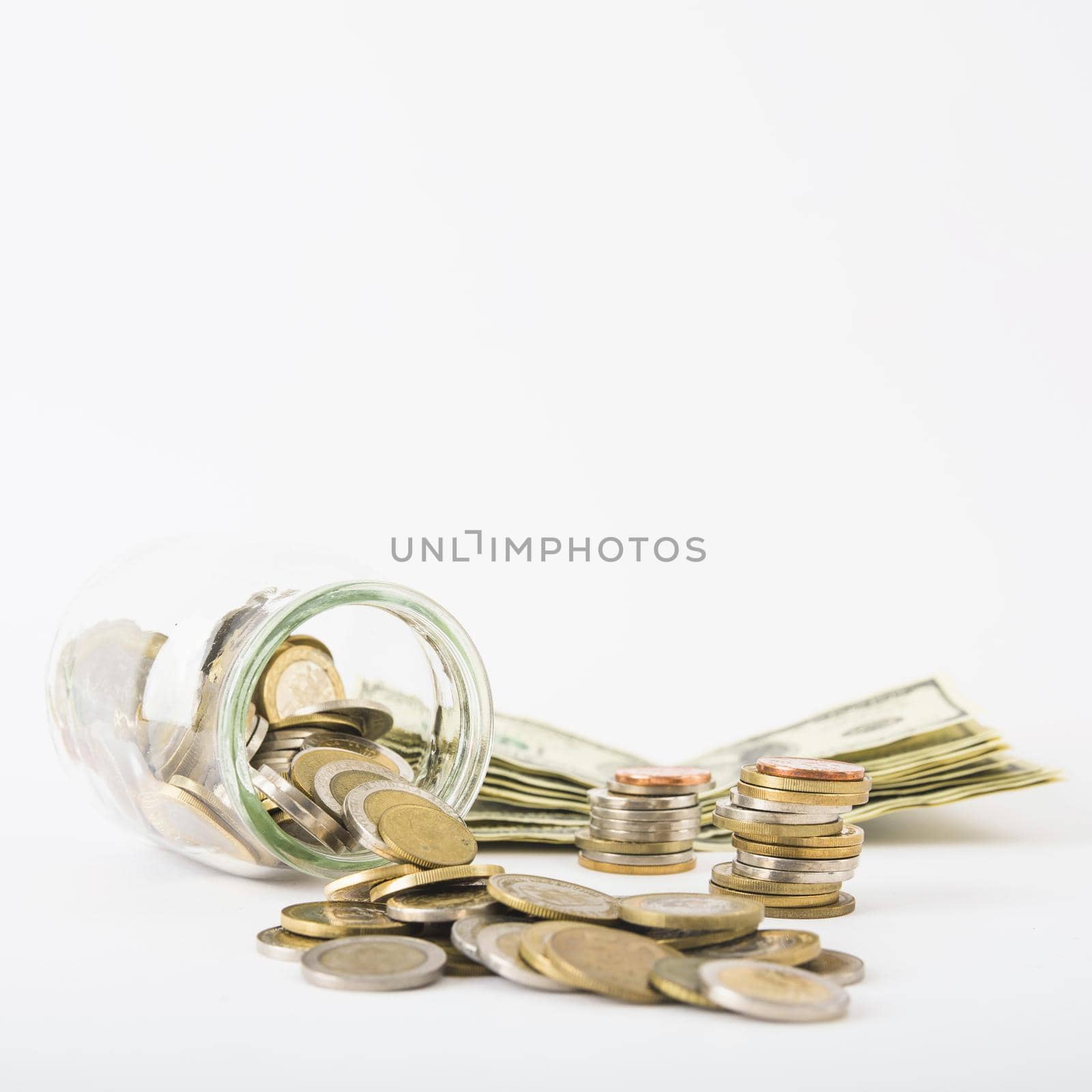 coins scattered from jar with paper money table. High quality beautiful photo concept by Zahard