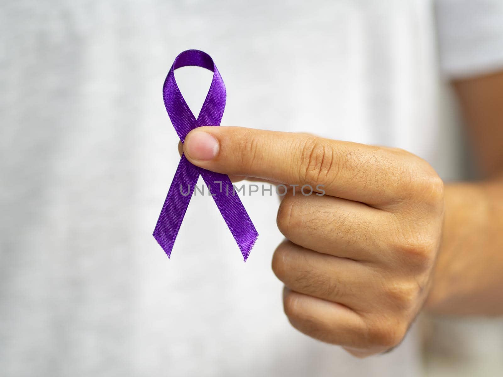 close up person holding up purple ribbon. Resolution and high quality beautiful photo