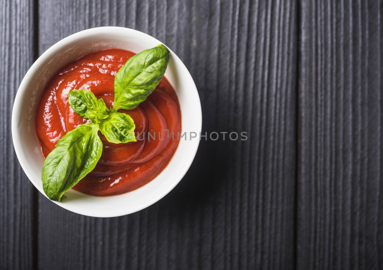 overhead view tomato sauce with green basil leaves wooden backdrop. Resolution and high quality beautiful photo