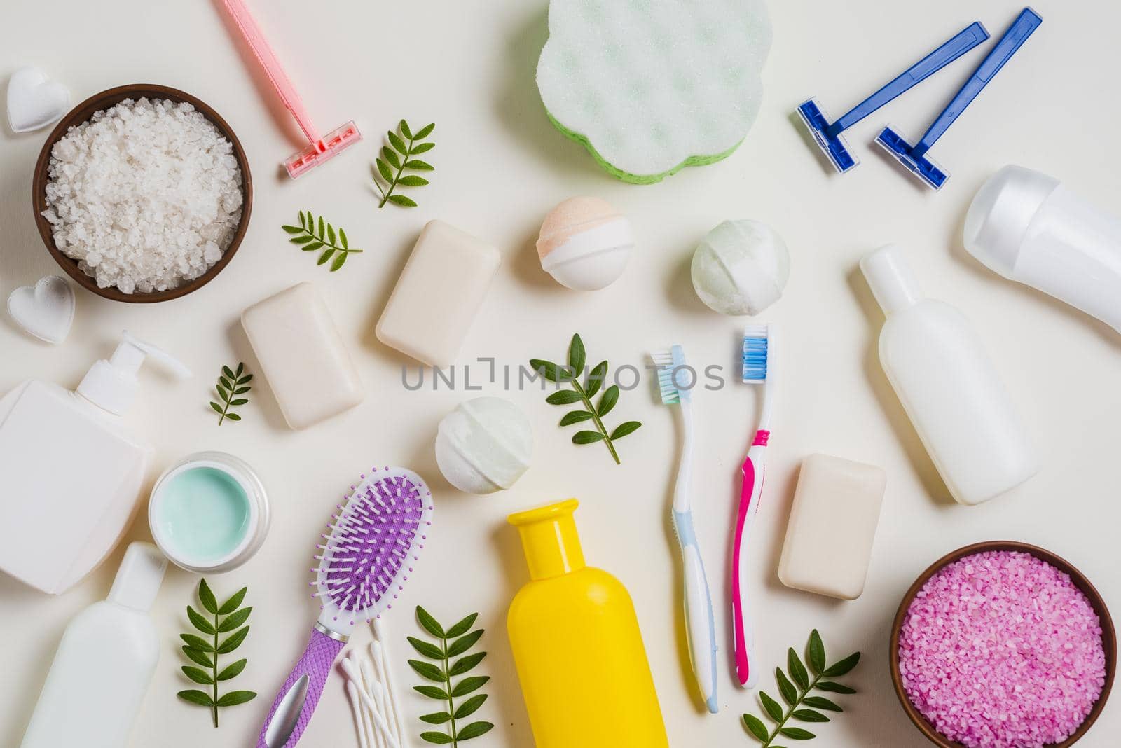 cosmetic products with salt toothbrush razor hairbrush leaves white backdrop. Resolution and high quality beautiful photo