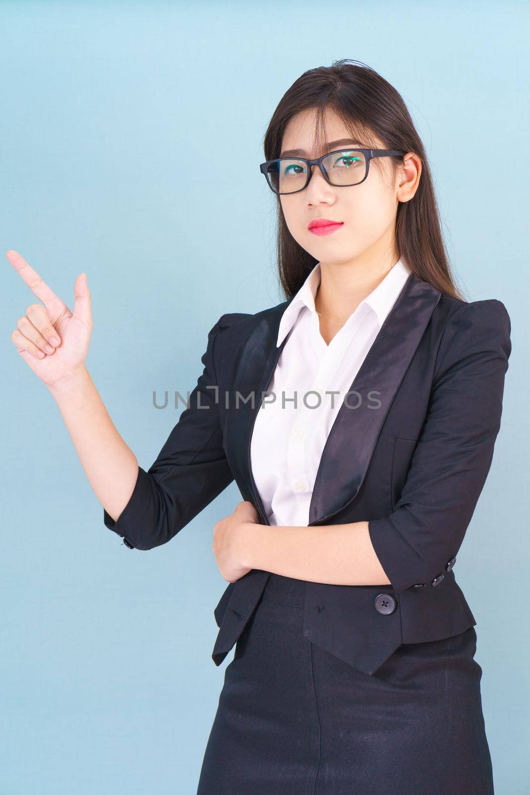 Business woman in suit with finger pointing up by stoonn