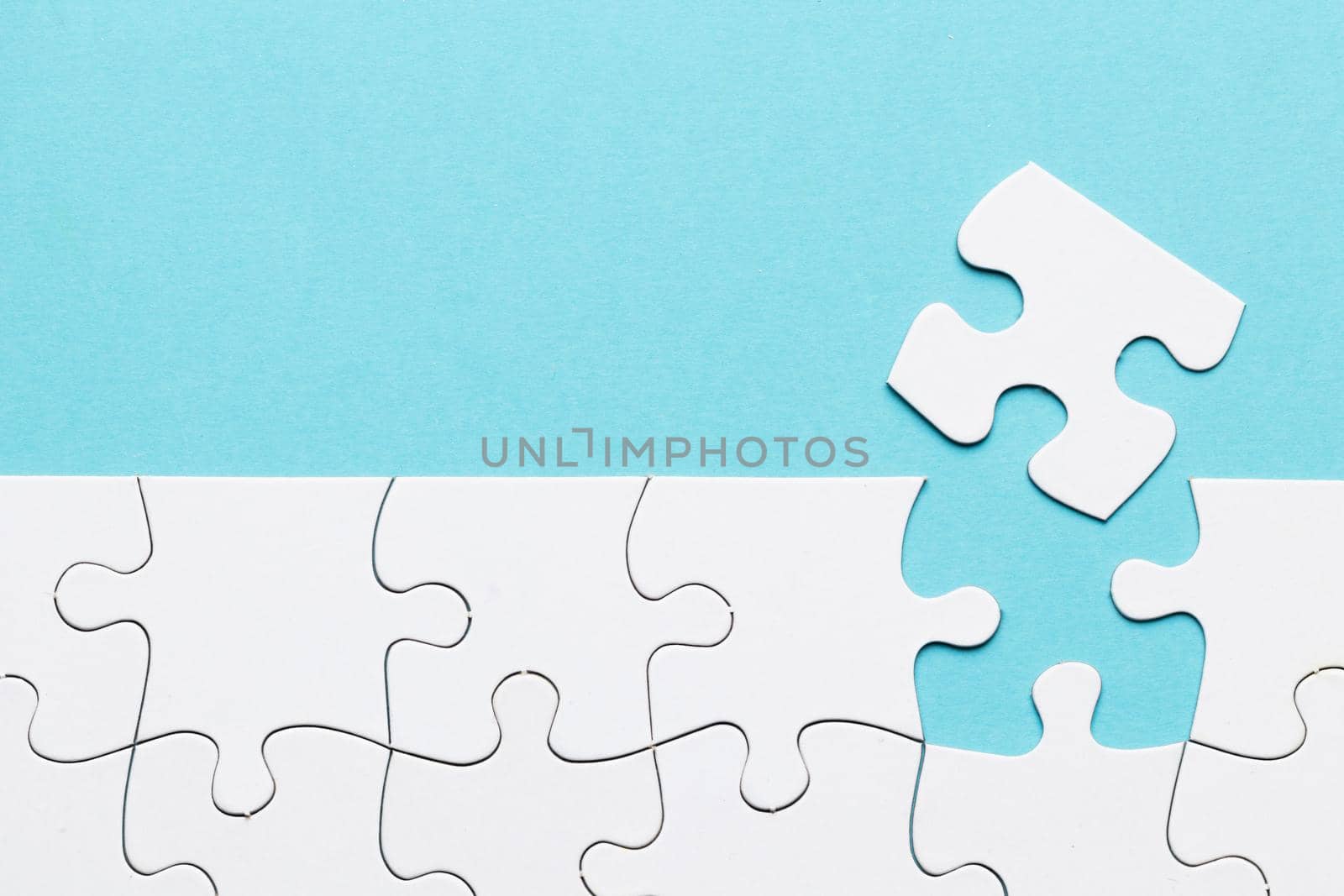 missing puzzle piece with white puzzle grid blue background. Resolution and high quality beautiful photo