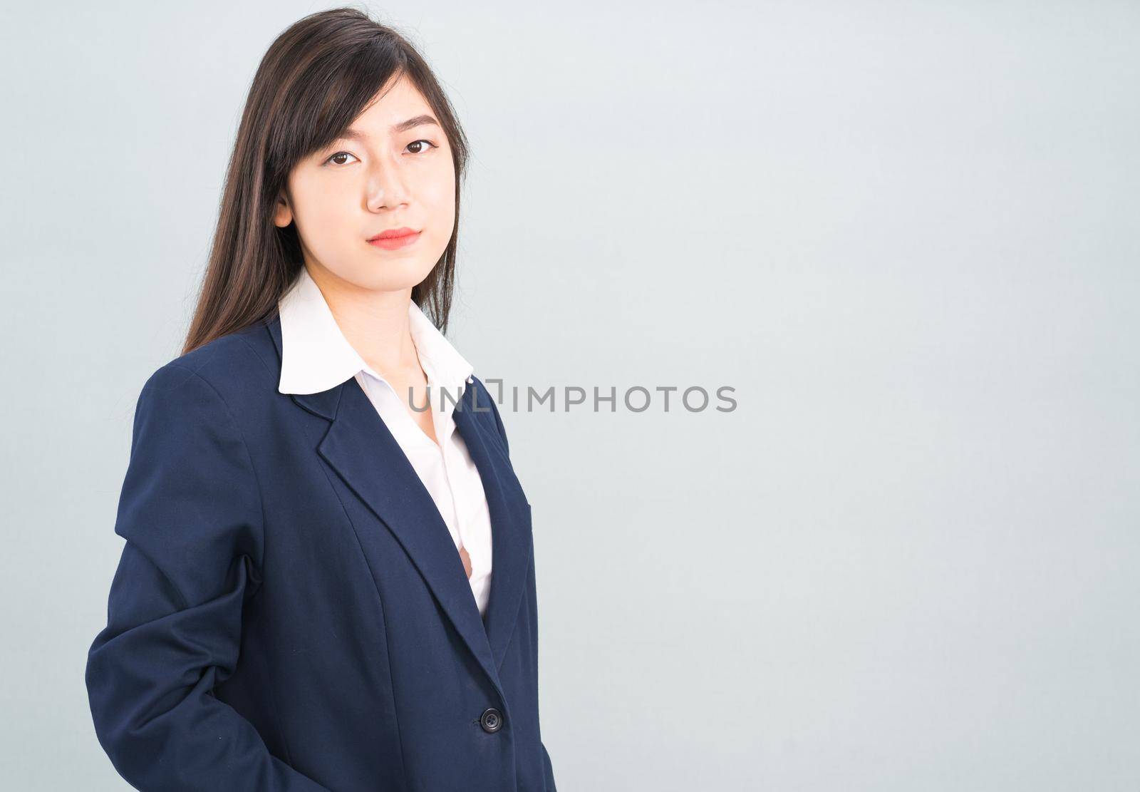 Portrait of asian businesswoman isolated on gray by stoonn