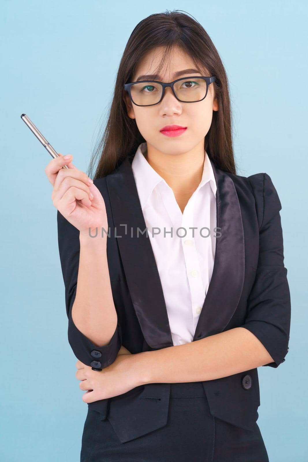 Teenage young asian wearing suit with support hand on chin isolated