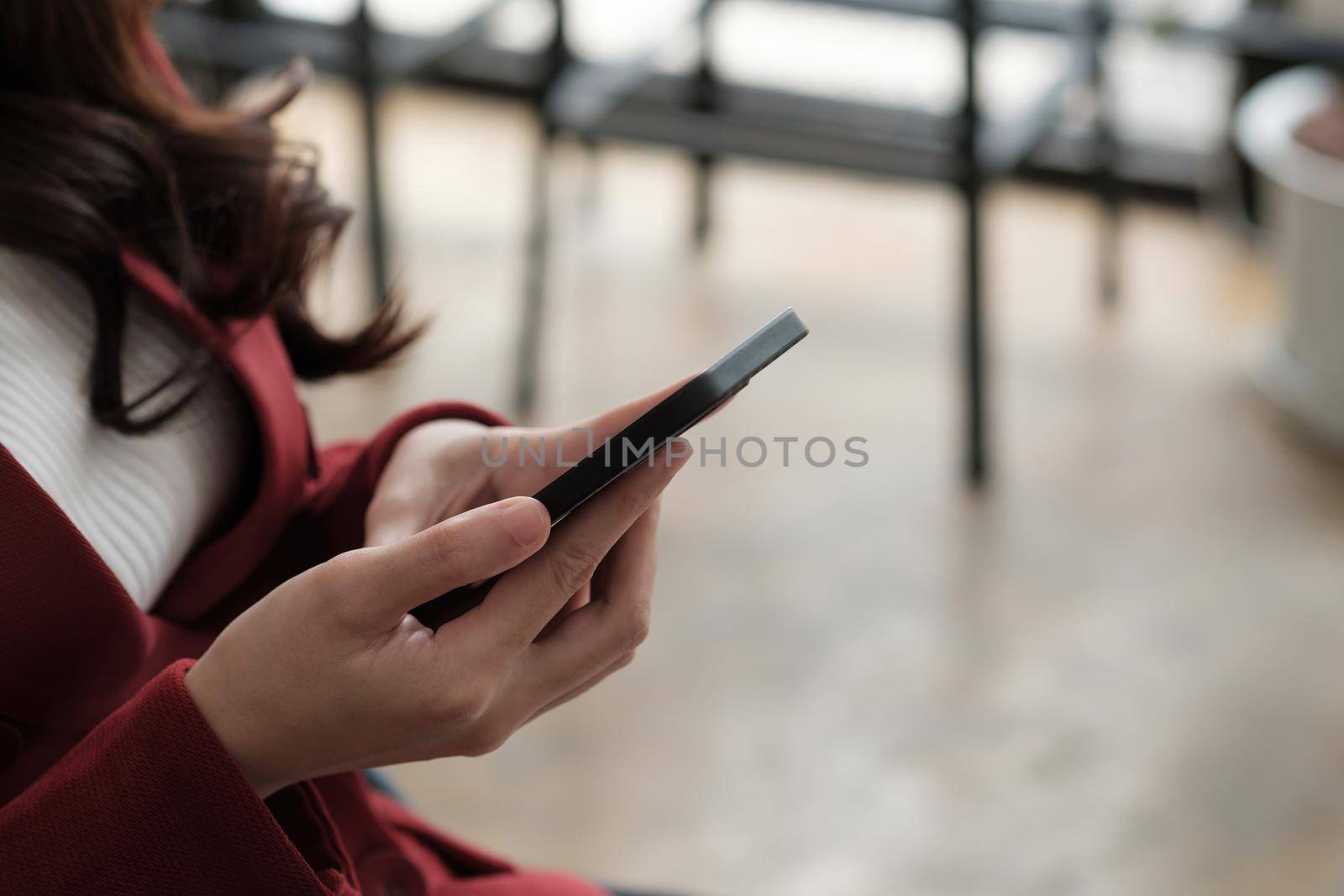 Close up women's hands use a smartphone for online shopping, social networking, or remote work.