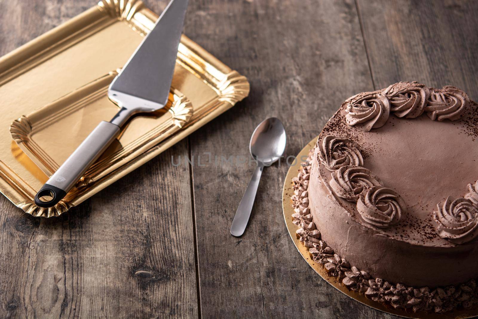 Piece of chocolate truffle cake on wooden table