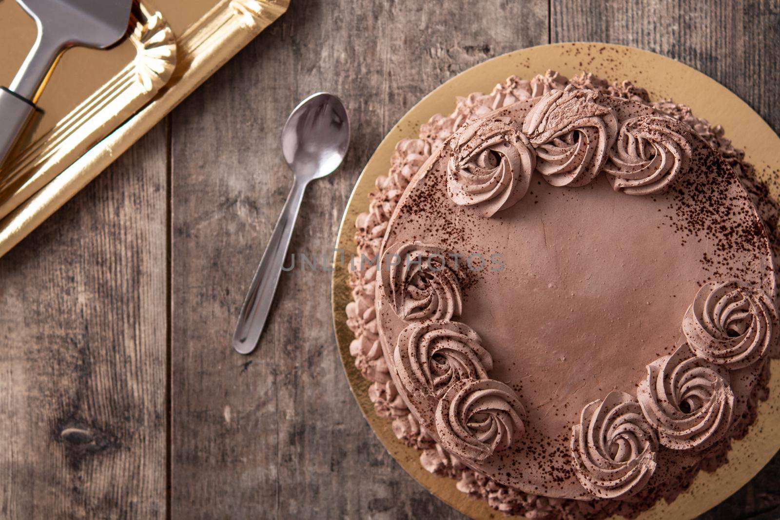 Piece of chocolate truffle cake on wooden table