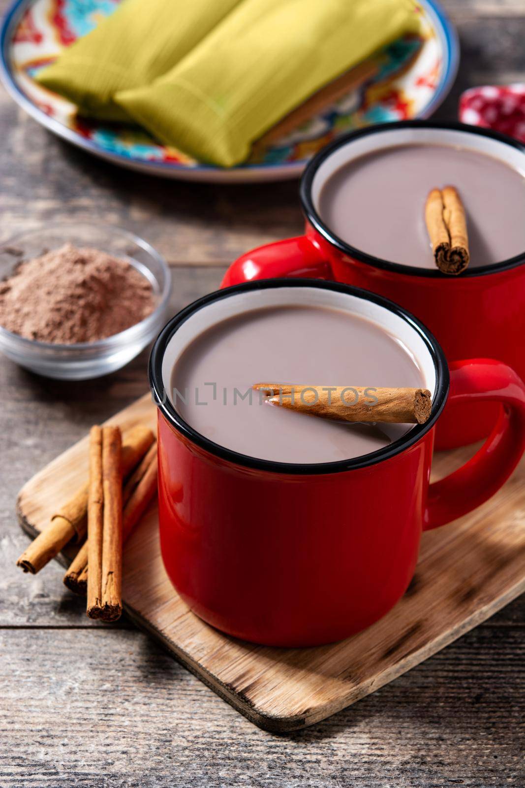 Traditional Mexican chocolate atole drink on wooden table