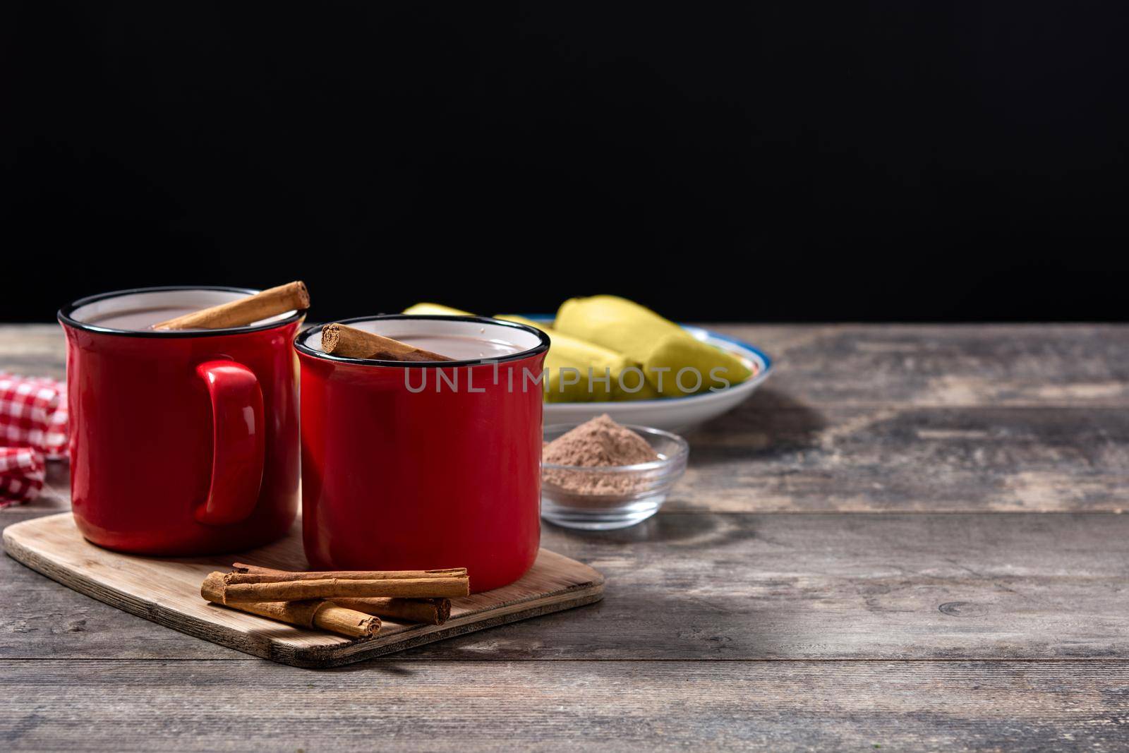 Traditional Mexican chocolate atole drink on wooden table