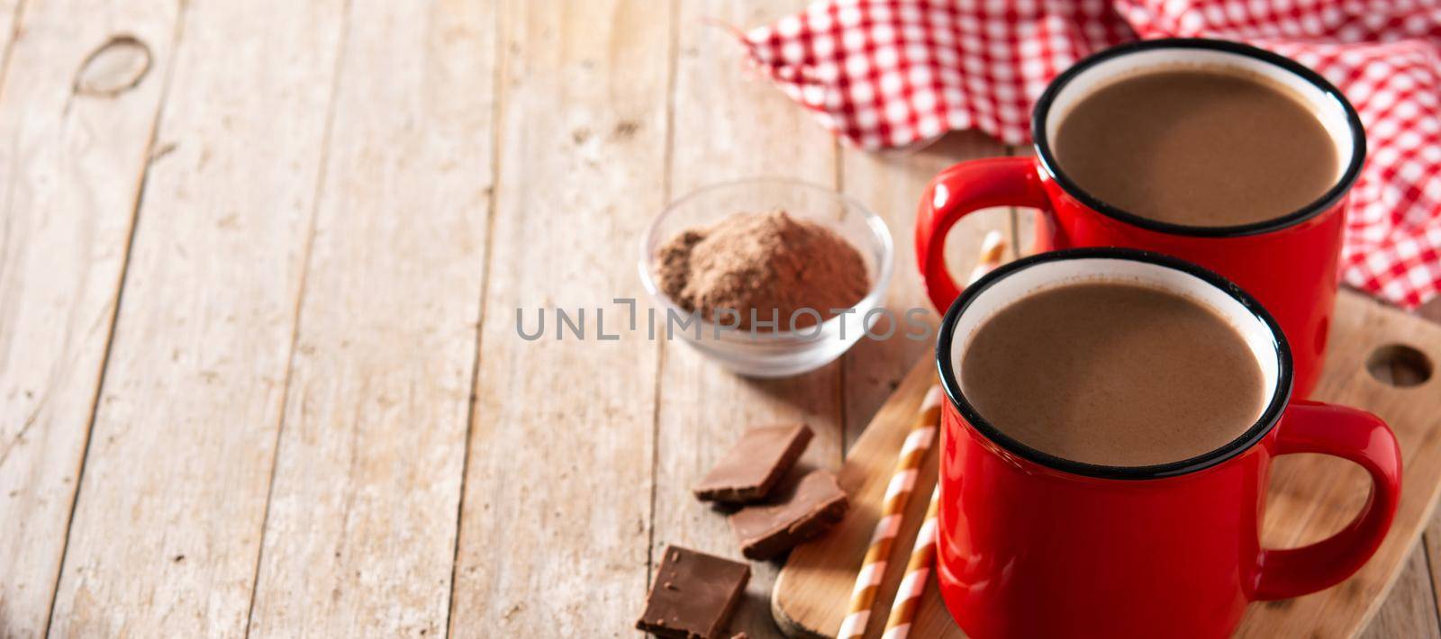 Traditional Mexican chocolate atole drink on wooden table