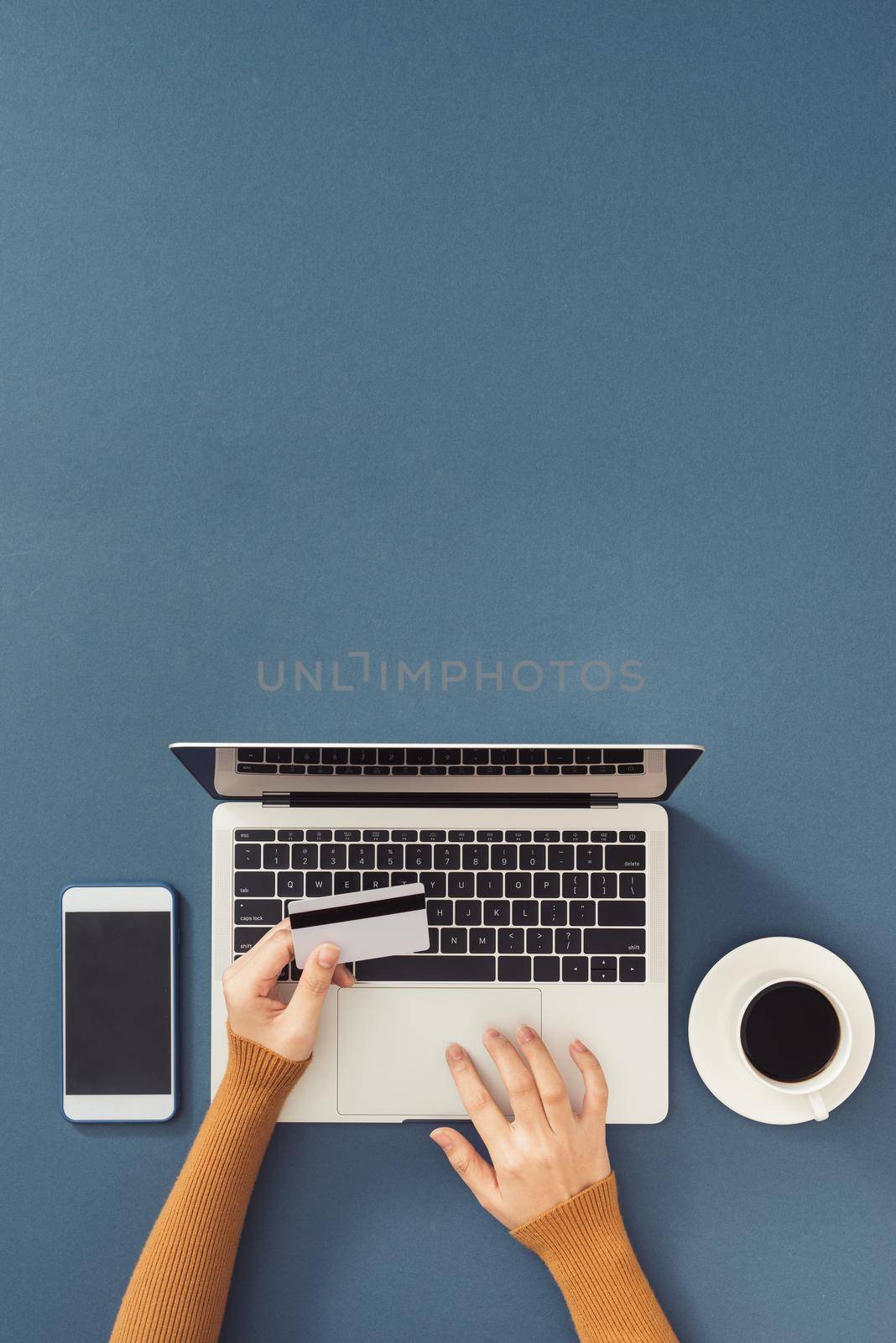 Top view of businessman office desk with credit card for online payment on laptop computer  flat lay on color background 