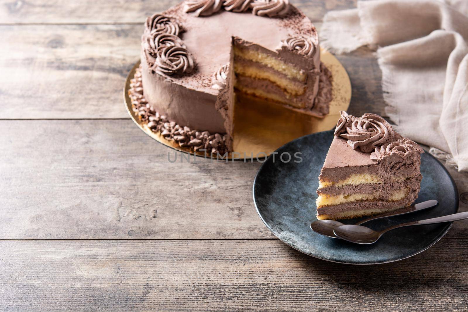 Piece of chocolate truffle cake on wooden table