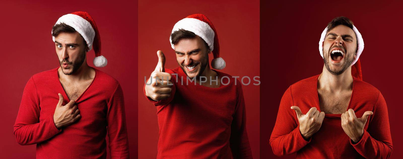 Young handsome caucasian guy in red sweater and Santa hats stands on red background in studio Shows how hot he is by andreonegin
