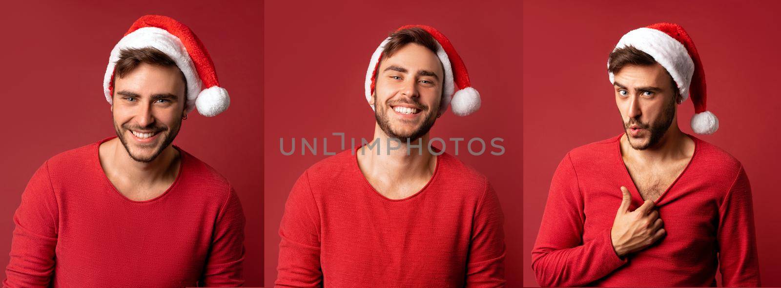 Man red sweater Santa hats stands on red background in studio pulls the sweater Shows how hot he is. Close up portrait european guy with Christmas mood. Holiday theme. New Year. Handspme caucasian guy