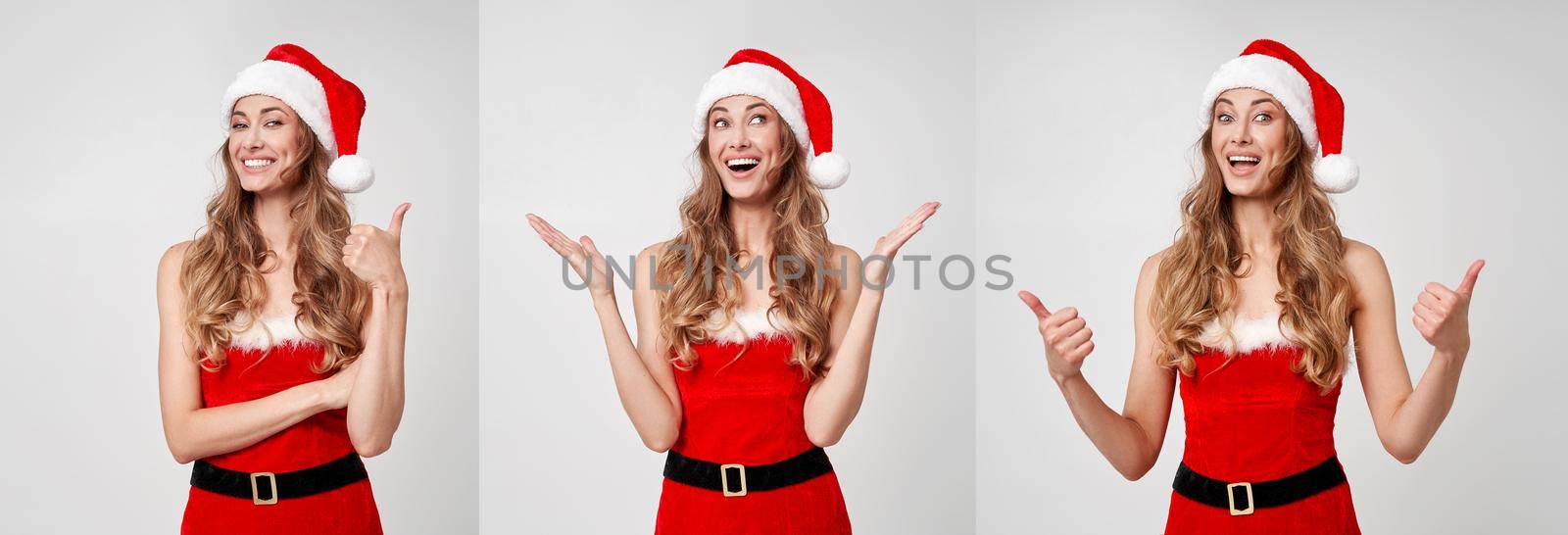 Woman christmas Santa Hat white studio background Beautiful caucasian female curly hair portrait Happy person positive emotion Holiday concept Showing Thumbs up gesture advertise some thing