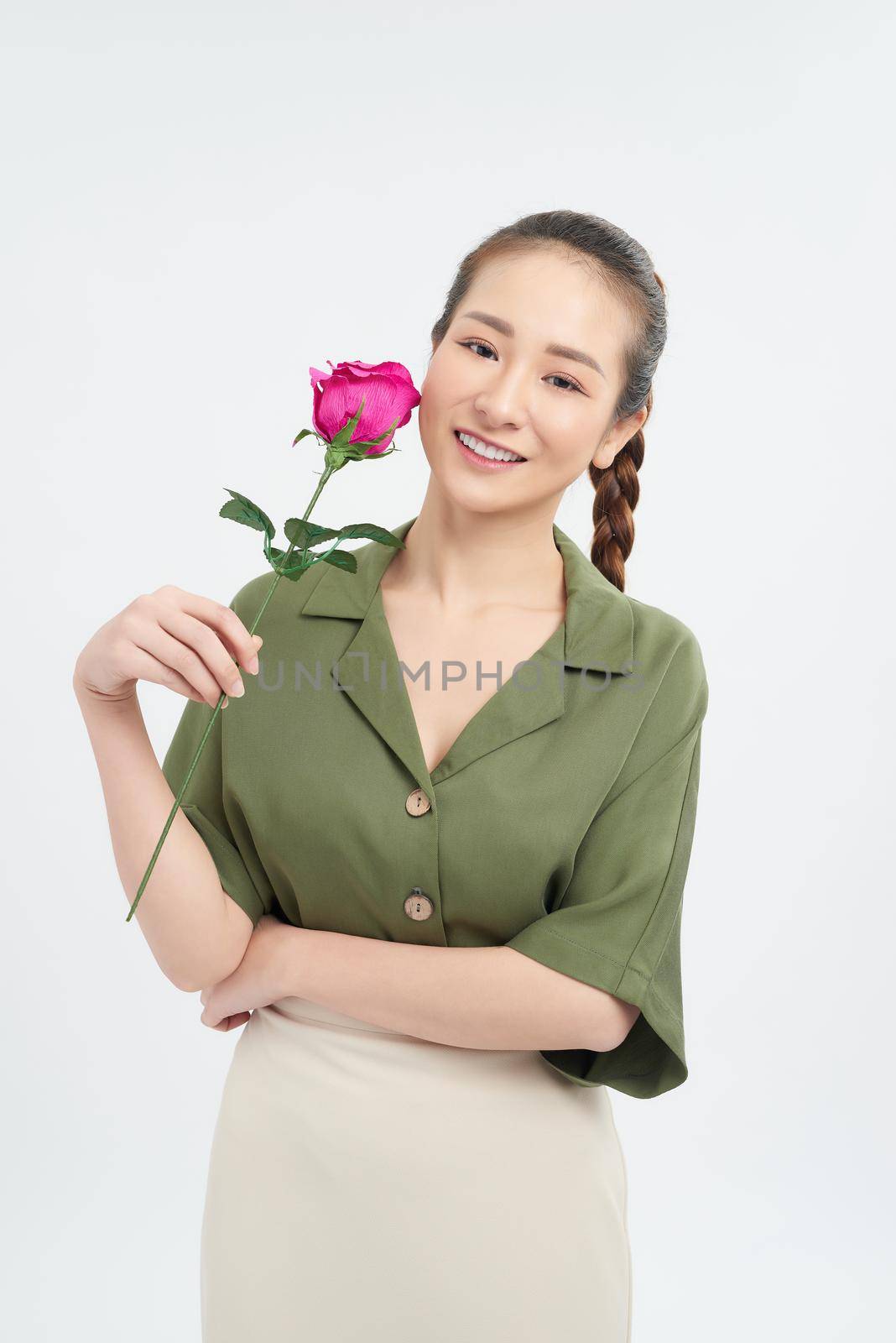 Young woman holding a single stem rose