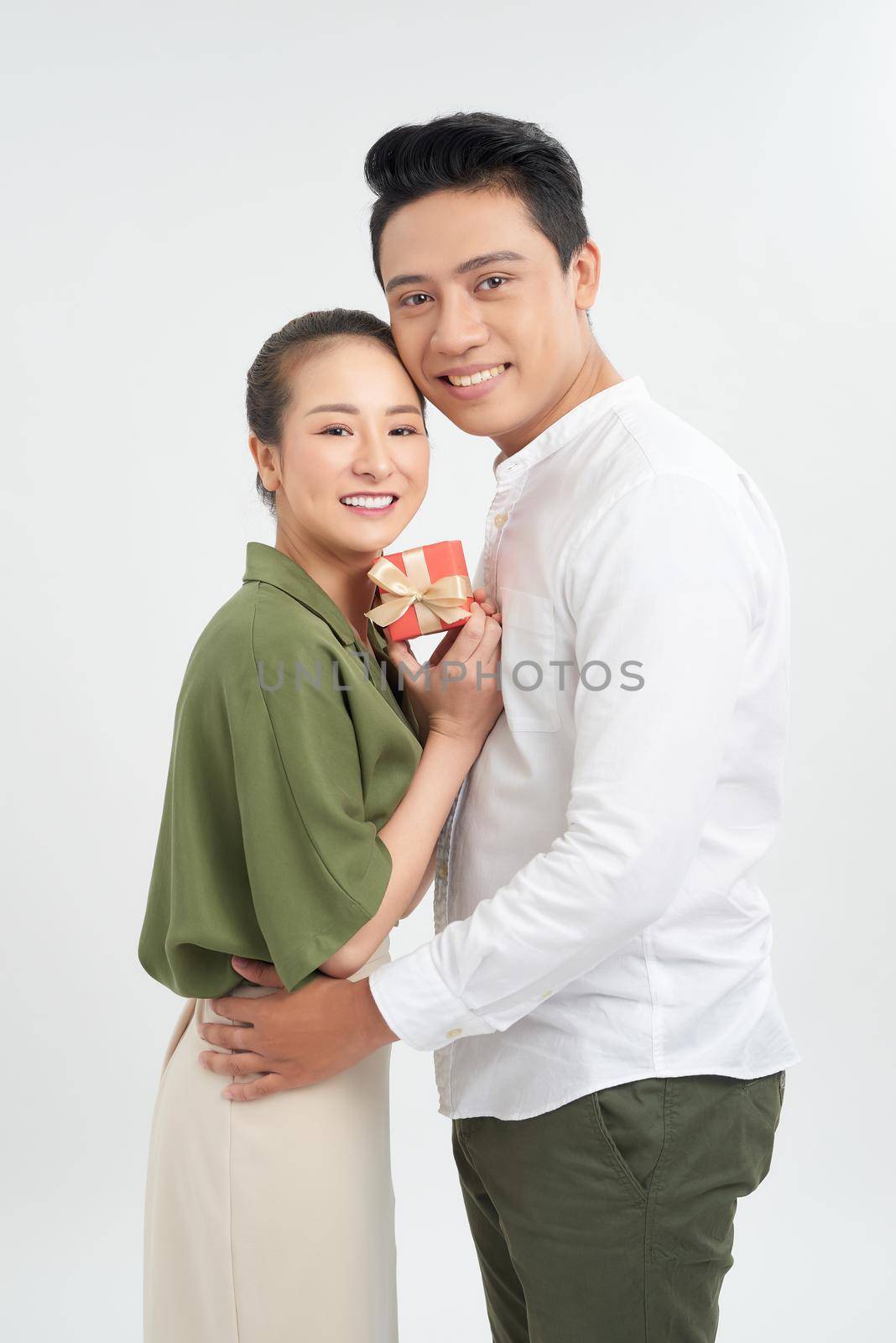 Happy Young Couple with Valentine's Day Present isolated on a White background.