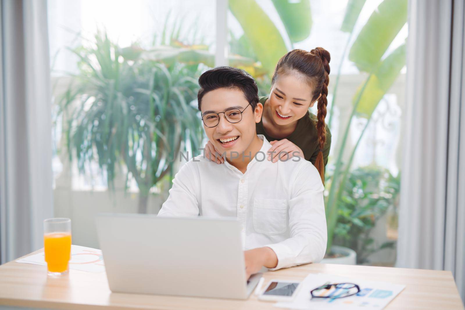 Happy family couple spending time together at home. Bright spacious apartment