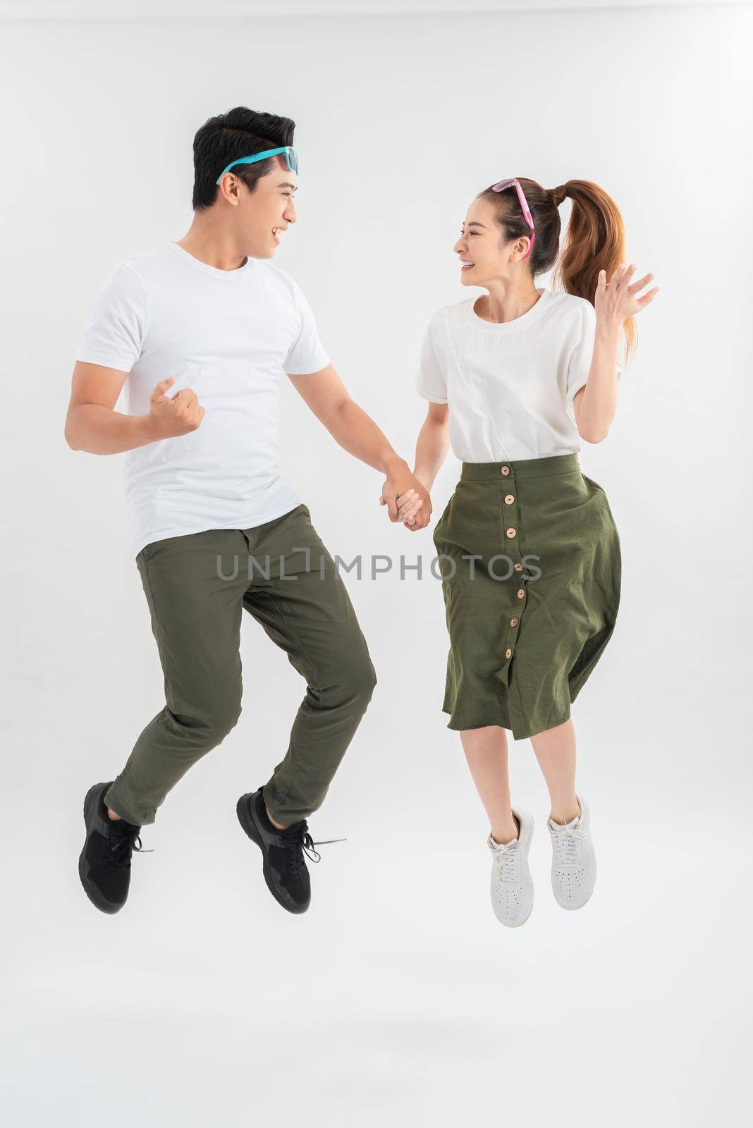 Glad girl having fun with boyfriend. Studio shot of couple fooling around in valentine's day.