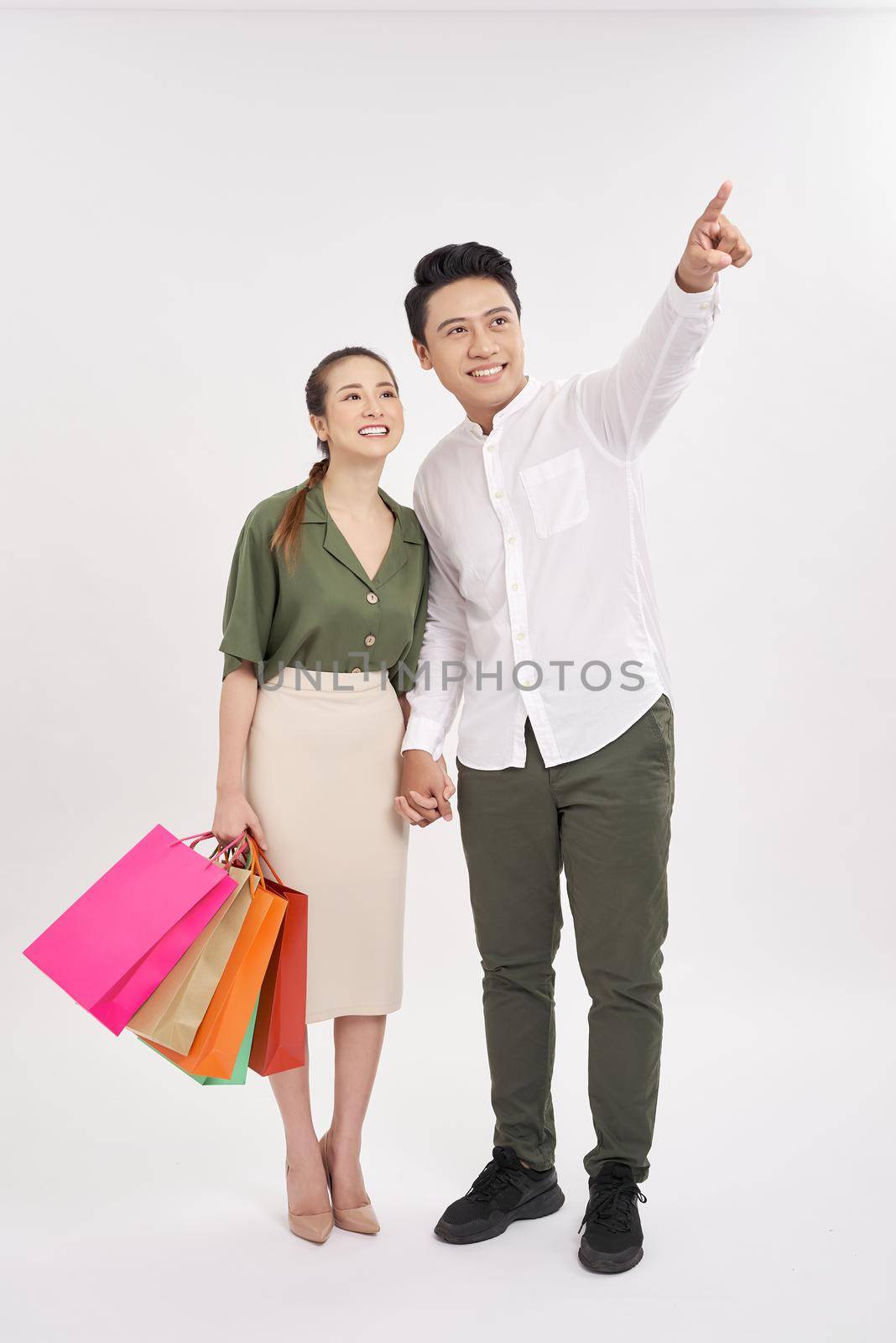 full body portrait of Romantic young couple shopping isolated on white background by makidotvn
