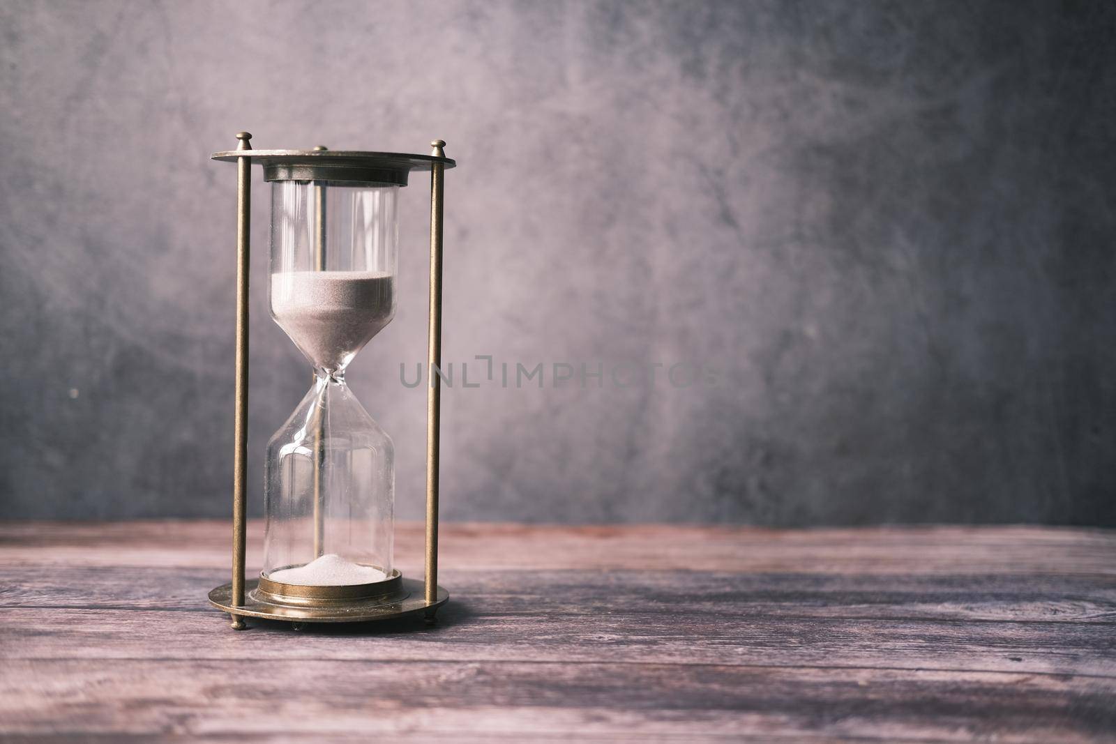 hourglass on table, Sand flowing through the bulb of Sandglass.