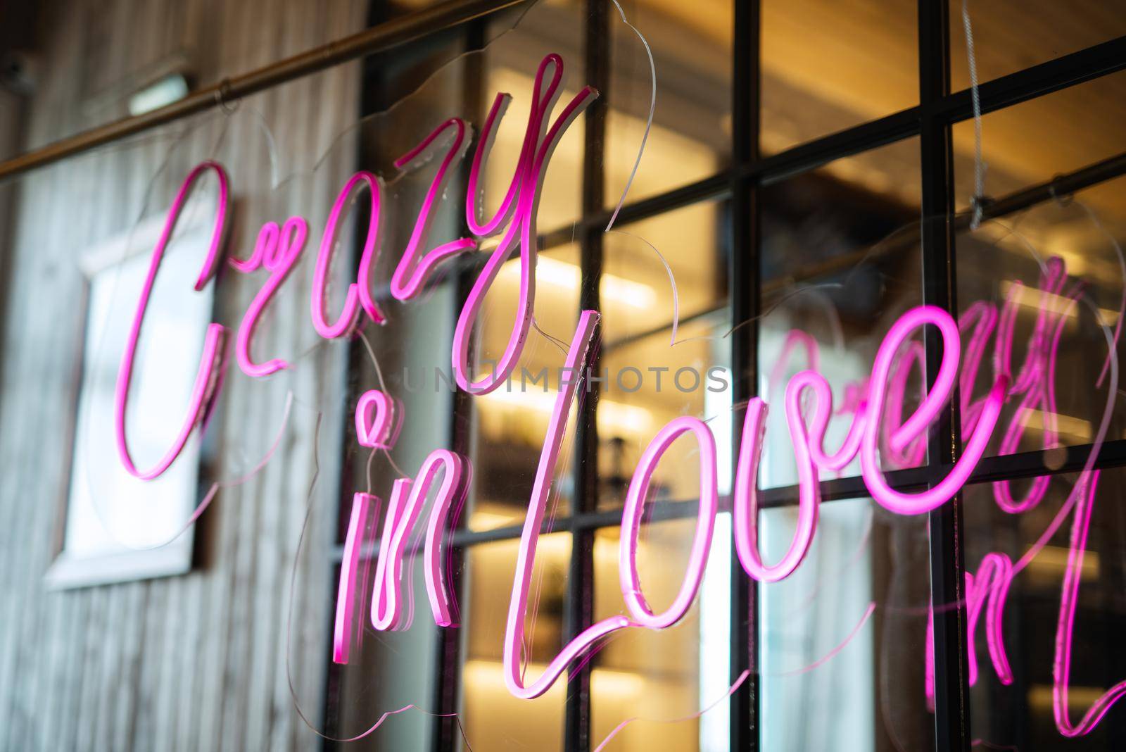 neon lettering in pink on a transparent border