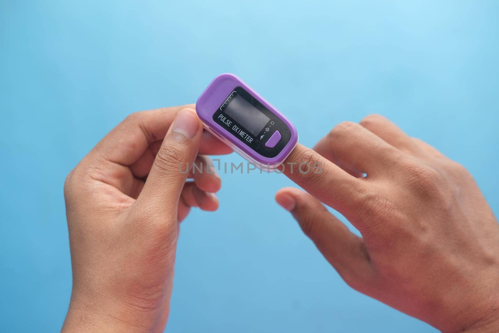 young man hand using pulse oximeter.