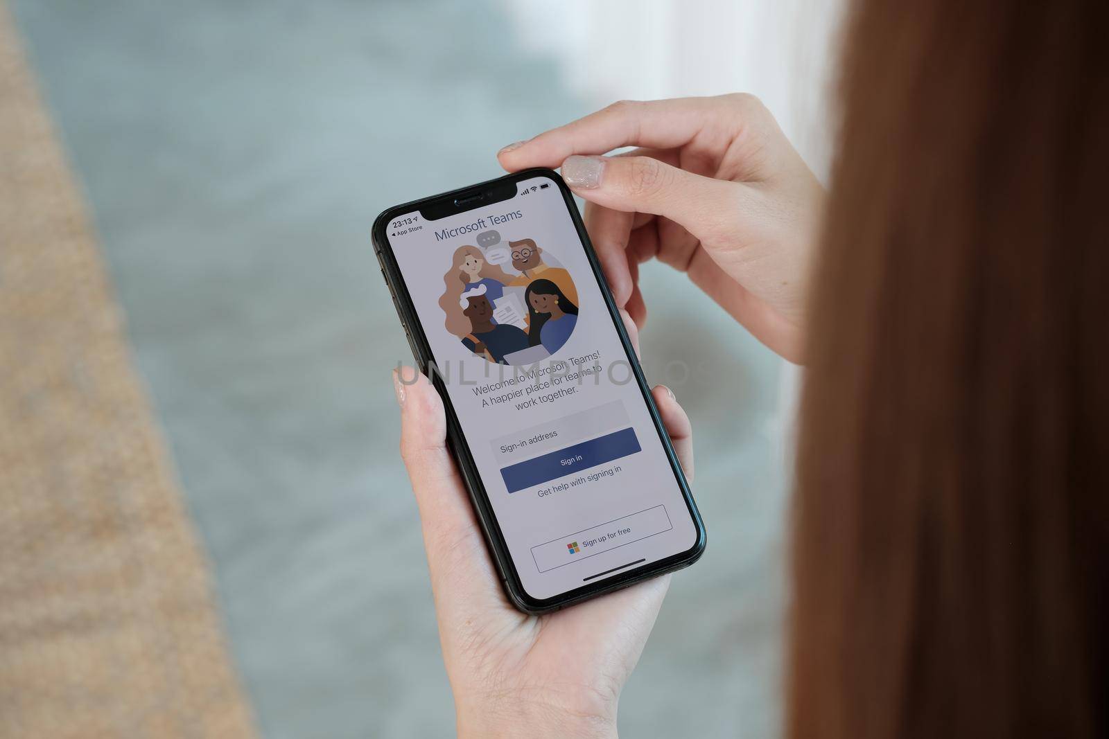 CHIANG MAI, THAILAND - 3 OCT, 2021 : A working from home employee is downloading the Microsoft Teams social platform, ready for remote working in isolation from home.