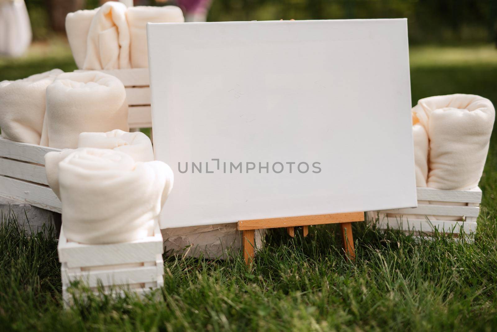 white plush blankets in wooden boxes for event invitees