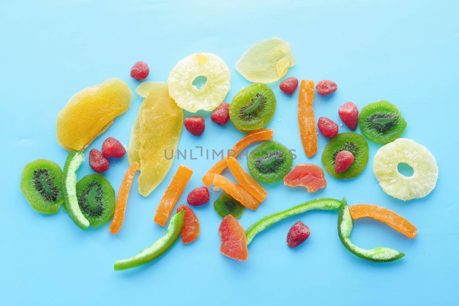 Dried fruits and berries on blue background .