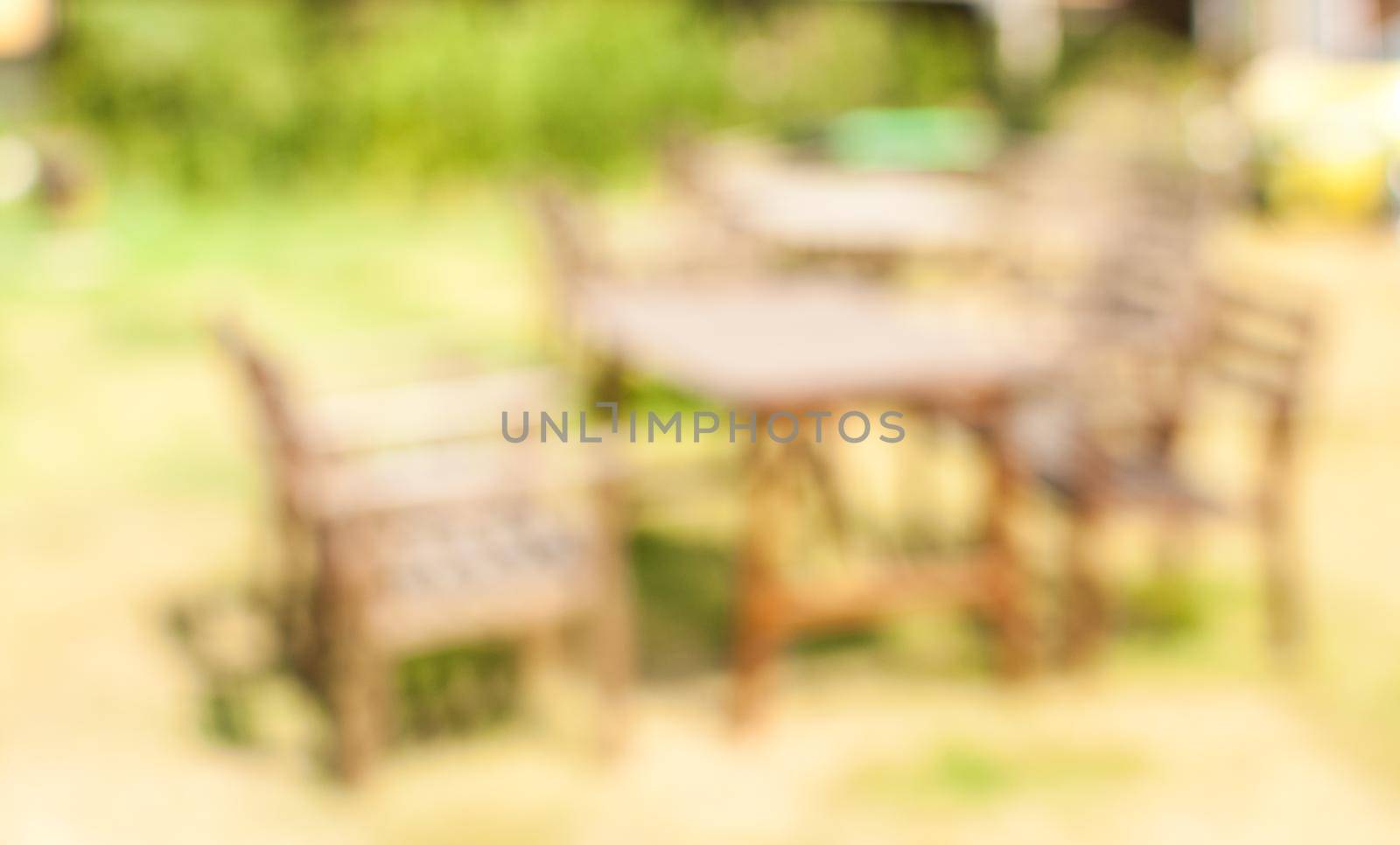 Outdoor restaurant with green garden in background. by Benzoix