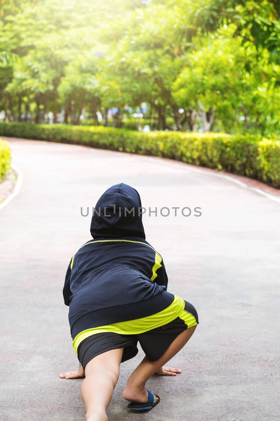 Asian Boy in position to run with arms on the ground.
