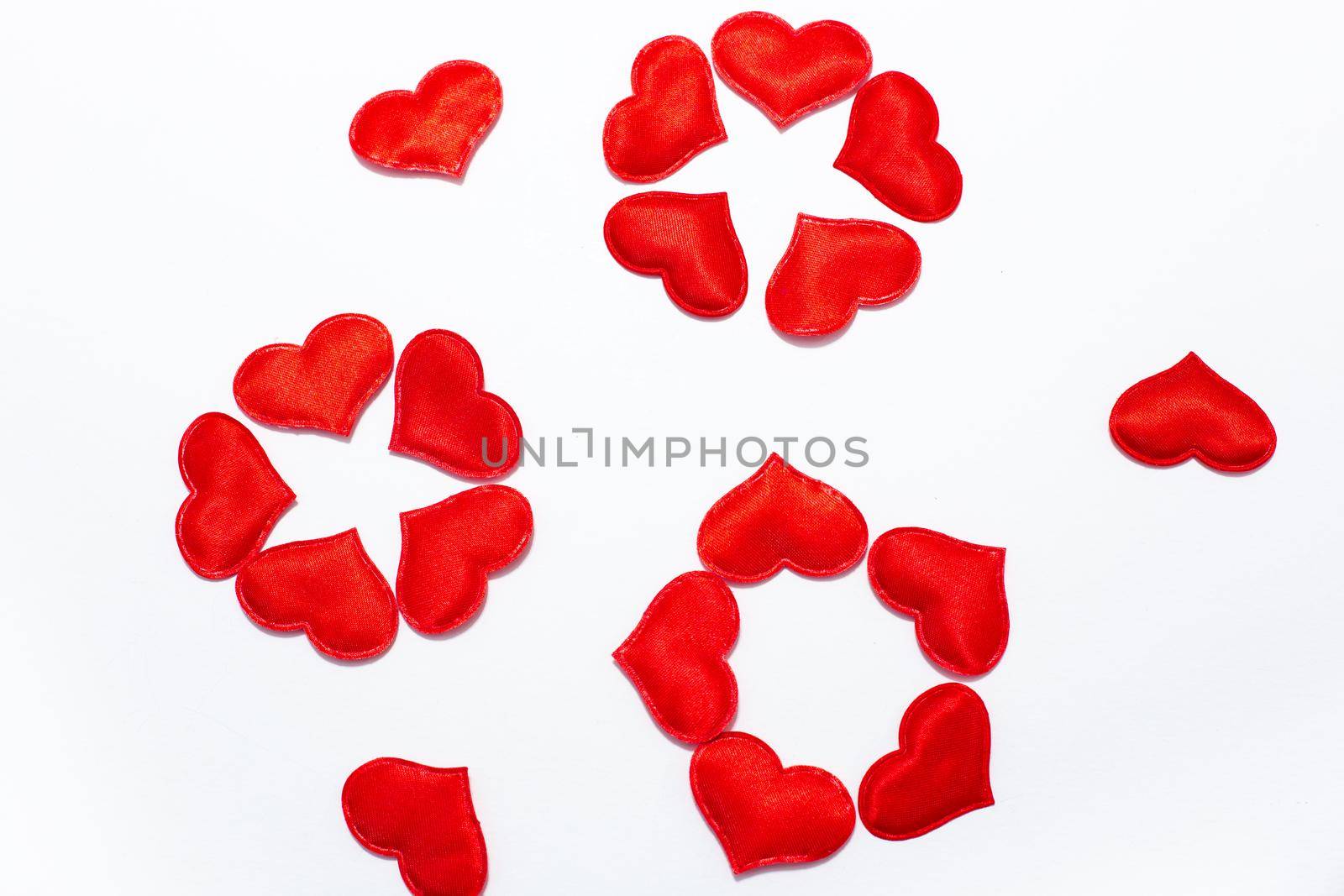 flowers laid out of red hearts on a white background
