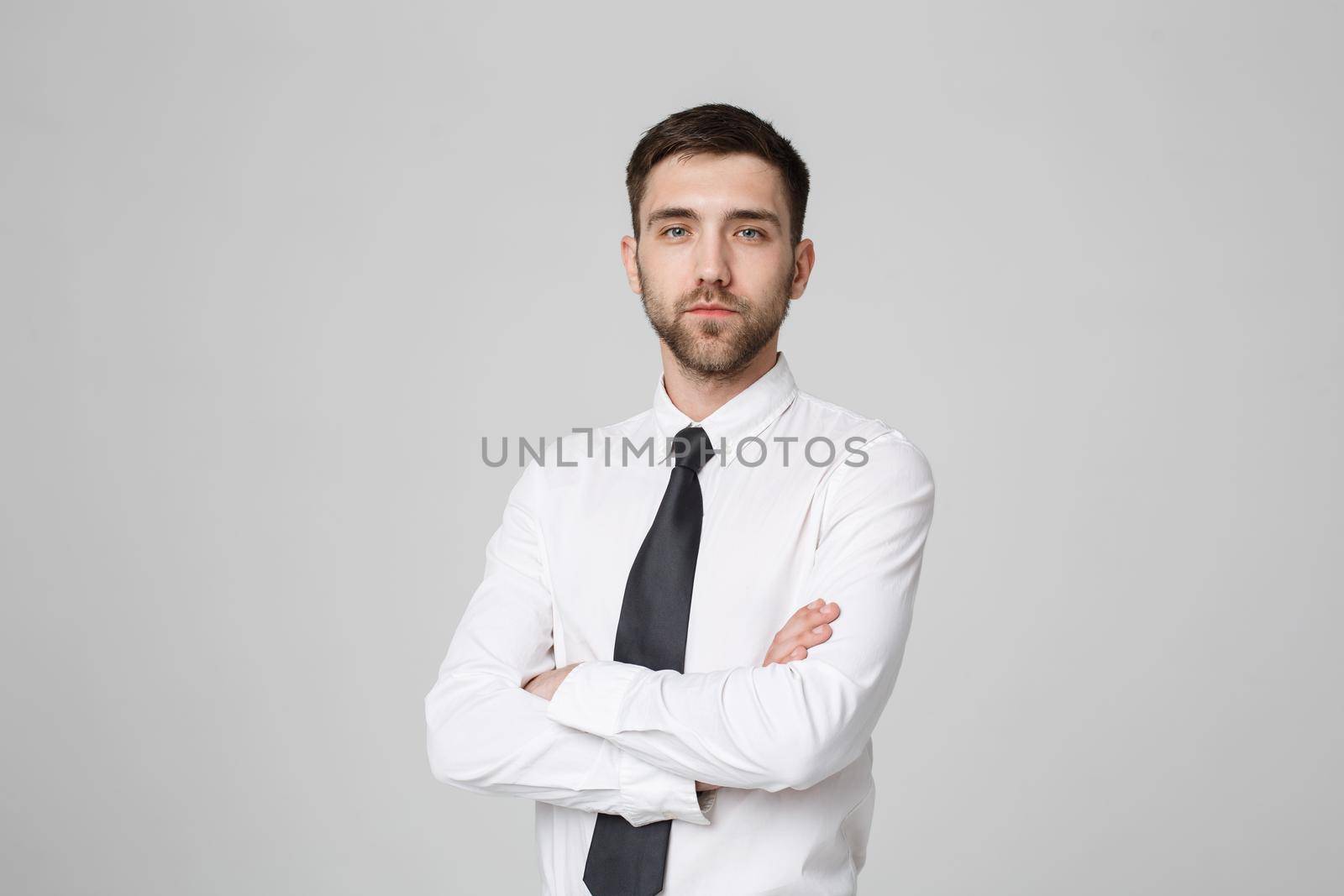 Business Concept - Portrait Handsome Business man crossing arms with confident face. White Background. Copy Space. by Benzoix